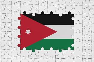 Jordan flag in frame of white puzzle pieces with missing central part photo