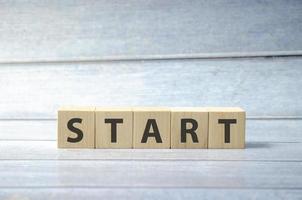 word start wooden blocks and blue background photo