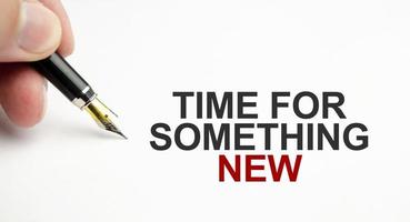 Time to something new - written on white paper with pen photo