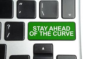 business concept. on laptop green button with the inscription - Stay Ahead of the curve photo
