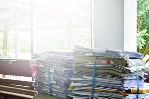 Used paper of various sizes is bundled together to sell or make recycled paper on the front porch of an office, soft focus, sunlight edited, environmental frineds concept. photo