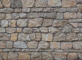 texture of old masonry wall made of rock stone photo