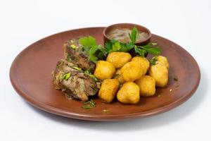 delicious baked meat with potatoes photo