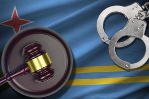 Aruba flag with judge mallet and handcuffs in dark room. Concept of criminal and punishment, background for judgement topics photo