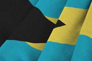 Bahamas flag with big folds waving close up under the studio light indoors. The official symbols and colors in banner photo