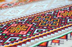 Traditional Ukrainian folk art knitted embroidery pattern on textile fabric photo