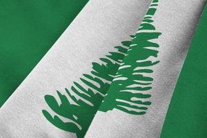 Norfolk island flag with big folds waving close up under the studio light indoors. The official symbols and colors in banner photo