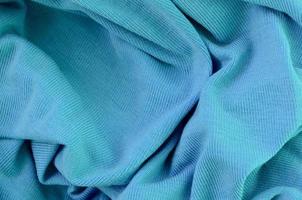 The texture of the fabric in blue color. Material for making shirts and blouses photo