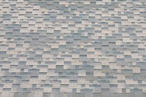 Background mosaic texture of flat roof tiles with bituminous coating photo