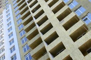 Residential multi store apartement building house facade under construction photo