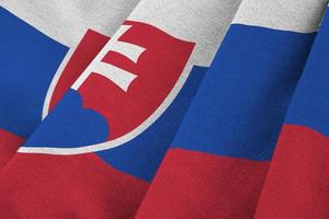 Slovakia flag with big folds waving close up under the studio light indoors. The official symbols and colors in banner photo