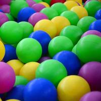 Swimming pool for fun and jumping in colored plastic balls photo