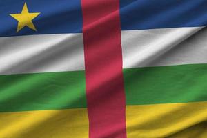 Central African Republic flag with big folds waving close up under the studio light indoors. The official symbols and colors in banner photo