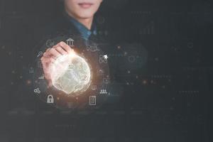 Businessman pointing with a pen at virtual icons,cyberspace network connection concept,and digital communication with a large database, photo