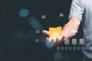 A businessman manages his organization's document database through the cloud. cyberspace technology concept and large important documents, file management and paperless online storage photo