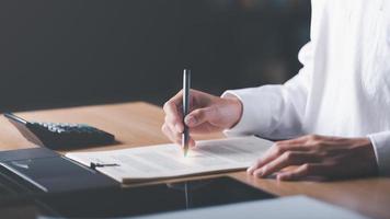 Businessman Audit documents, quality assessment management With a checklist, business document evaluation process, market data report analysis and consulting, plan review process. photo
