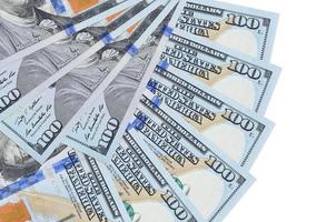 100 US dollars bills lies isolated on white background with copy space stacked in fan shape close up photo
