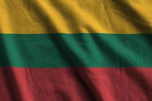 Lithuania flag with big folds waving close up under the studio light indoors. The official symbols and colors in banner photo