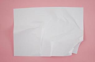 Abstract crumpled paper texture isolated in pink background photo