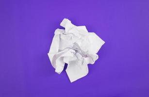 Abstract crumpled paper texture isolated in purple background photo