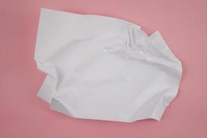 Abstract crumpled paper texture isolated in pink background photo