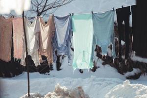 washed clothes hang on a string in the cold, hardened. photo