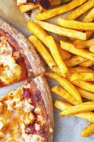 Unhealthy concept. Fast Food - Pizza, Fried Potato. Close up. Popular fast food recipes photo