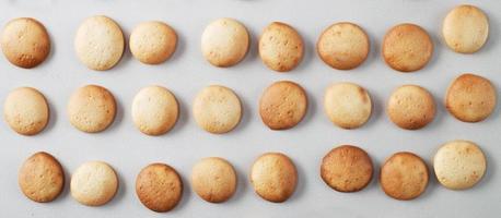 A pattern of small pancakes. Background from orange toasted round biscuits. home bakery. banner photo