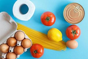 Different healthy food products on a blue background. Top view. fruit, vegetable, eggs and grocery online shop.your text photo