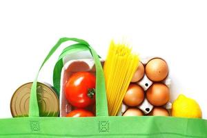 Full green bag of healthy products food on a white background. Top view. online shop. your text. food delivery photo