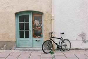 Old bicycle parking front of door house photo