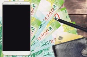 200 russian rubles bills and smartphone with purse and credit card. E-payments or e-commerce concept. Online shopping and business with portable devices photo