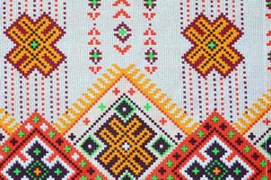 Traditional Ukrainian folk art knitted embroidery pattern on textile fabric photo