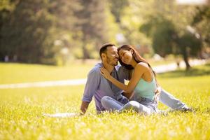 Happy young couple in love at the grass field photo