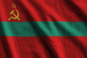 Transnistria flag with big folds waving close up under the studio light indoors. The official symbols and colors in banner photo
