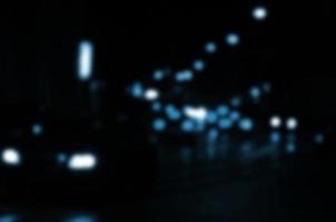 Blurred night scene of traffic on the roadway. Defocused image of cars traveling with luminous headlights. Bokeh Art photo