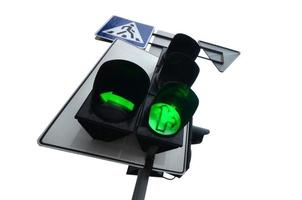 Traffic lights with the green light lit isolated on white photo