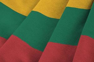 Lithuania flag with big folds waving close up under the studio light indoors. The official symbols and colors in banner photo