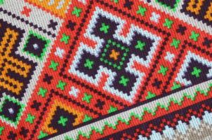 Traditional Ukrainian folk art knitted embroidery pattern on textile fabric photo