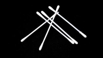 Isolated a couple pieces of cotton bud with black background. photo