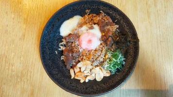 A Menu from a sushi restaurant Beef Garlic Fried Rice with Onsen Egg is onion fried rice with half-cooked beef and egg, very tasty. photo