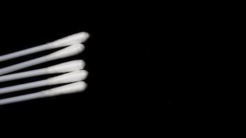 Isolated a couple pieces of cotton bud with black background. photo