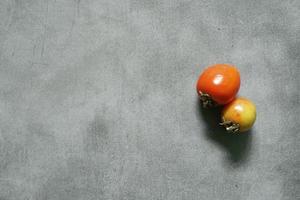cute red tomatoes on a concrete background photo