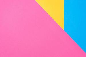 Multicolored paper background. Yellow pink and blue geometric backdrop. photo