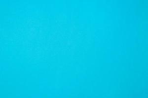 Blue textured paper background, top view. Simple one-color backdrop photo