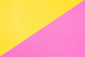 Two color paper textured background. Yellow and pink diagonal geometric backdrop. photo