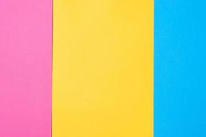 Three colored vertical layers, copy space. Multicolored paper background. Yellow pink and blue geometric backdrop. photo