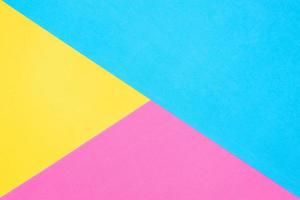 Multicolored paper background. Yellow pink and blue geometric backdrop. Diagonal and triangles photo