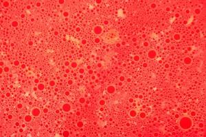 Abstract red background with round spots of various shapes. photo