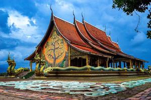 Sirindhorn Wararam Phu Prao Temple of Thailand, a unique image is a glow of the sculpture of the Kalpapruek, which is attached to the wall behind the church. It will appear green glow in the night. photo